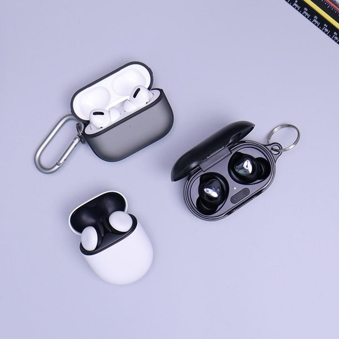 Two pairs of true wireless earbuds with charging cases on a clean white surface
