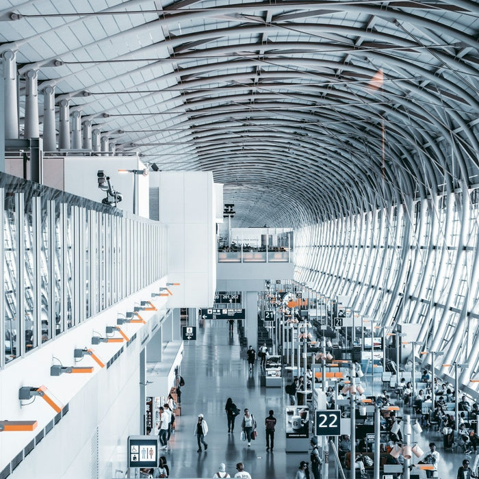 A modern airport terminal interior with multilingual signs