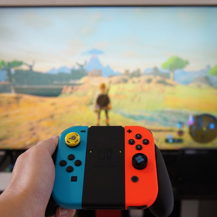 Nintendo Switch console in handheld mode with red and blue Joy-Con controllers attached, screen displaying a game