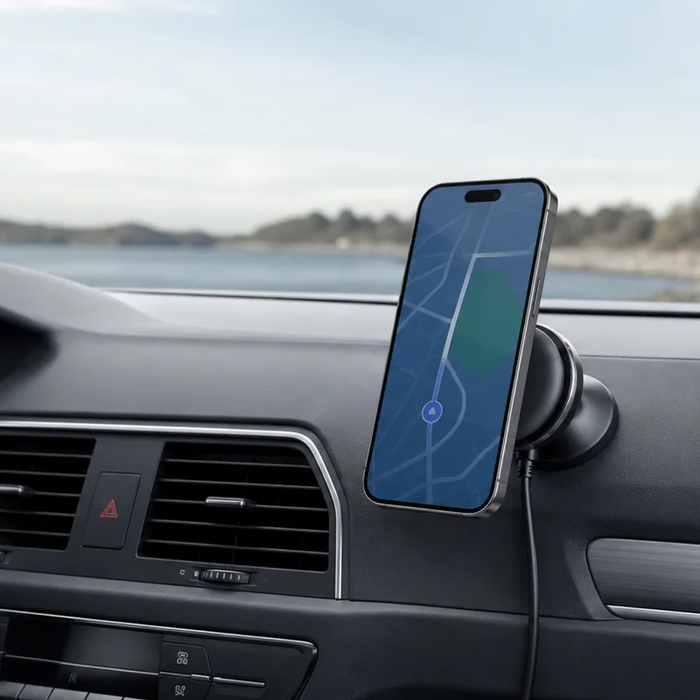 A smartphone on a magnetic wireless charging mount beside a modern car dashboard